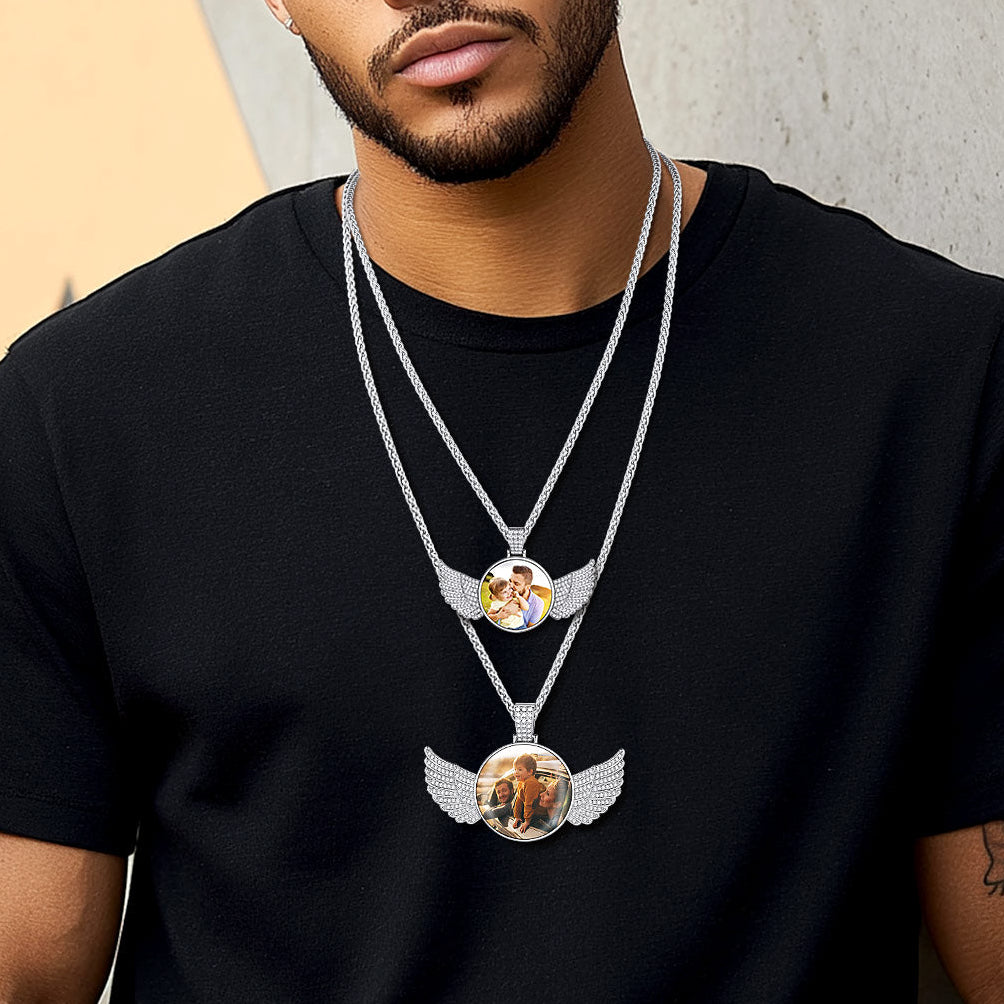 Man wearing a black t-shirt with a necklace featuring a pendant.