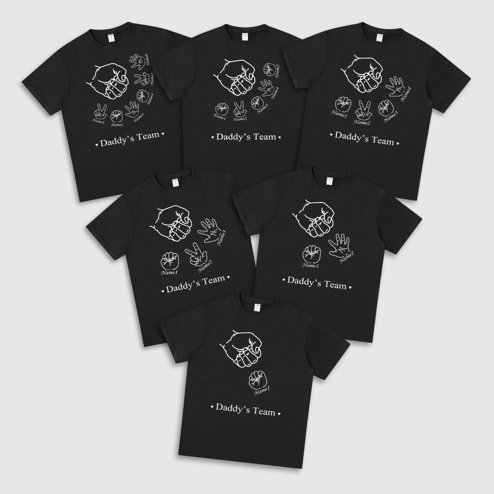 Set of black t-shirts with 'Daddy's Team' text and hand illustrations on a white background