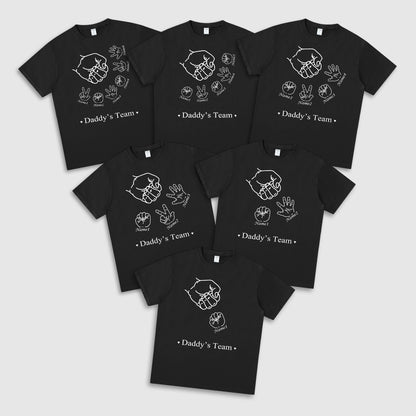 Set of black t-shirts with 'Daddy's Team' text and hand illustrations on a white background