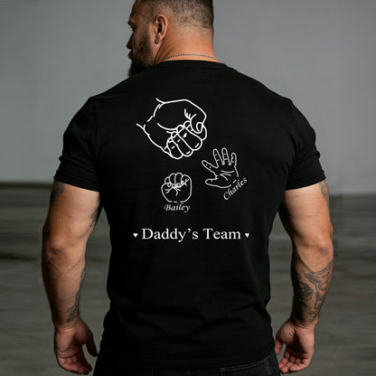 Man wearing a black t-shirt with white graphics and text on the back.