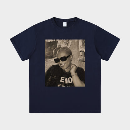 Navy blue t-shirt with a graphic of a person wearing sunglasses and a hat on a light gray background