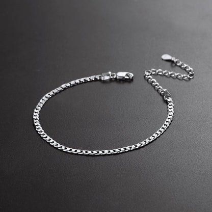 Silver chain bracelet on a dark gray background