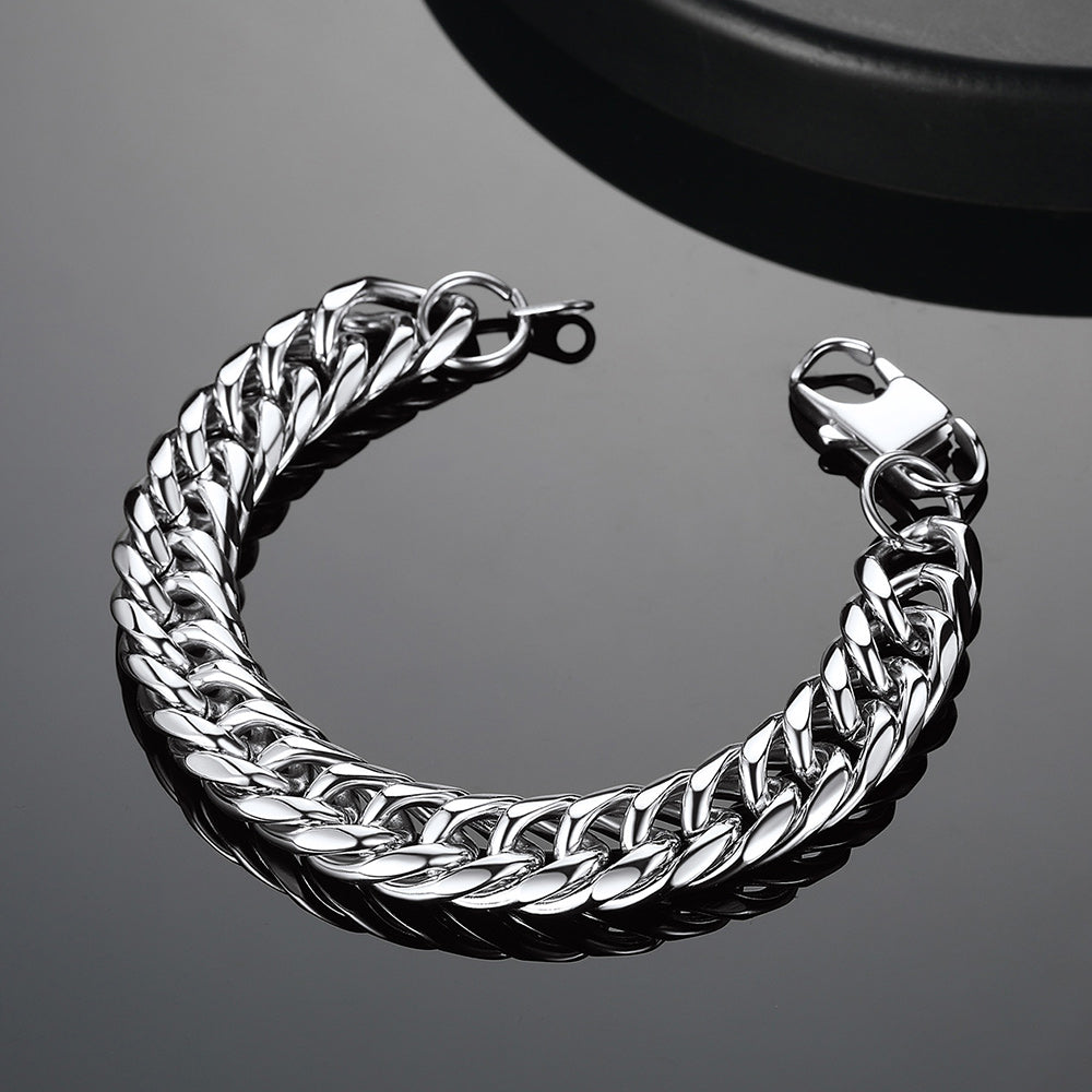 Silver chain bracelet on a reflective black surface