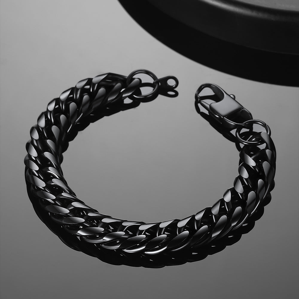 Black chain bracelet on a reflective surface
