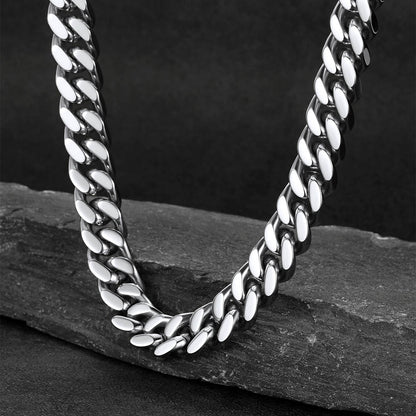 Chunky Cuban link choker necklace laid flat on white background, thick statement chain