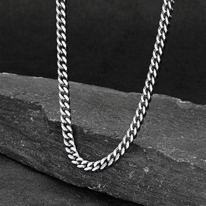 Chunky Cuban link choker necklace laid flat on white background, thick statement chain