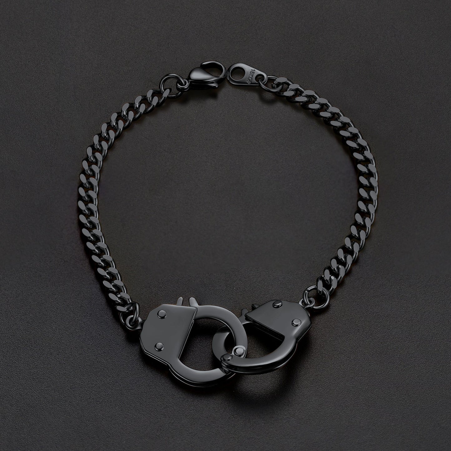 Black chain bracelet with handcuff links on a dark background