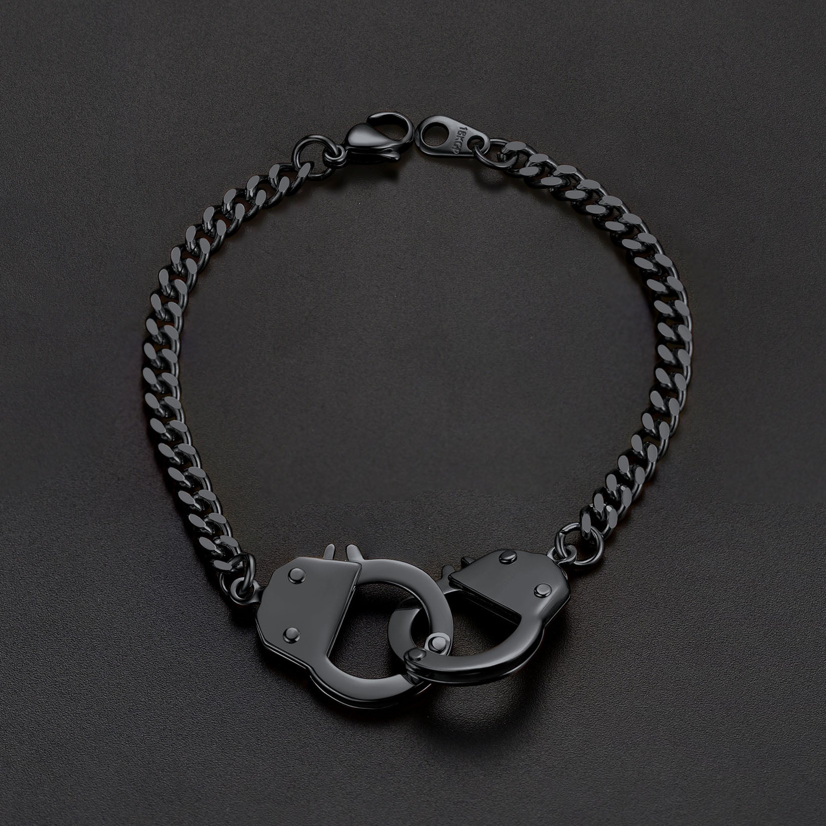 Black chain bracelet with handcuff links on a dark background