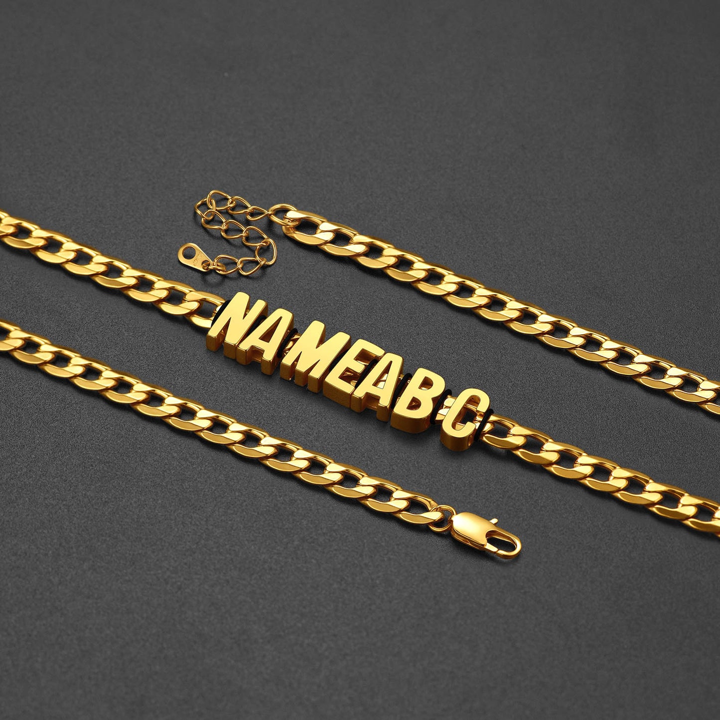 Gold chain with embedded letters 'NAMEABC' on a dark gray background