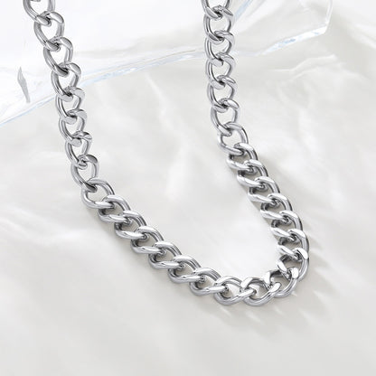 Silver chain necklace on a light gray background