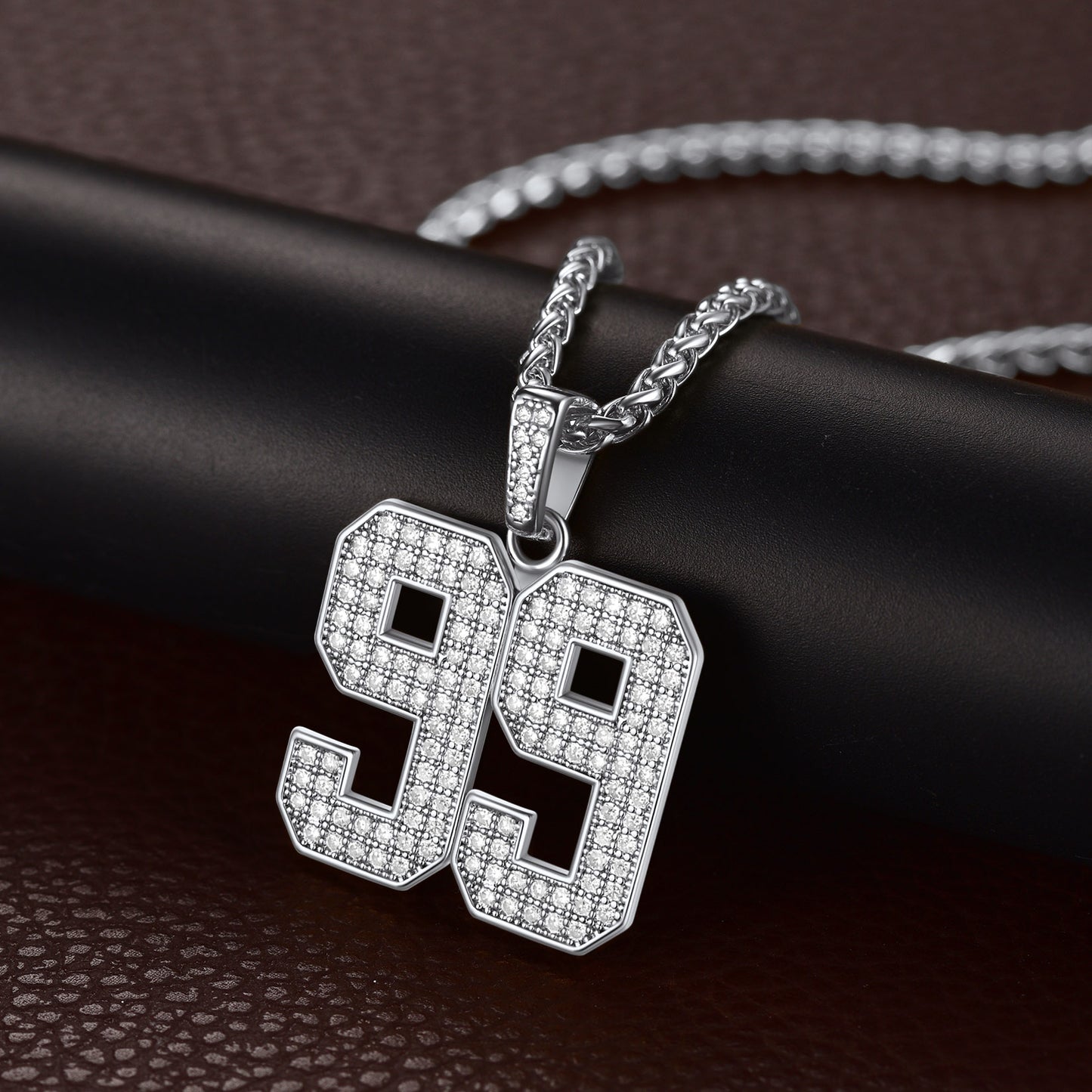 Silver Cubic Zirconia Custom Number Necklace with a '99' pendant on a dark surface