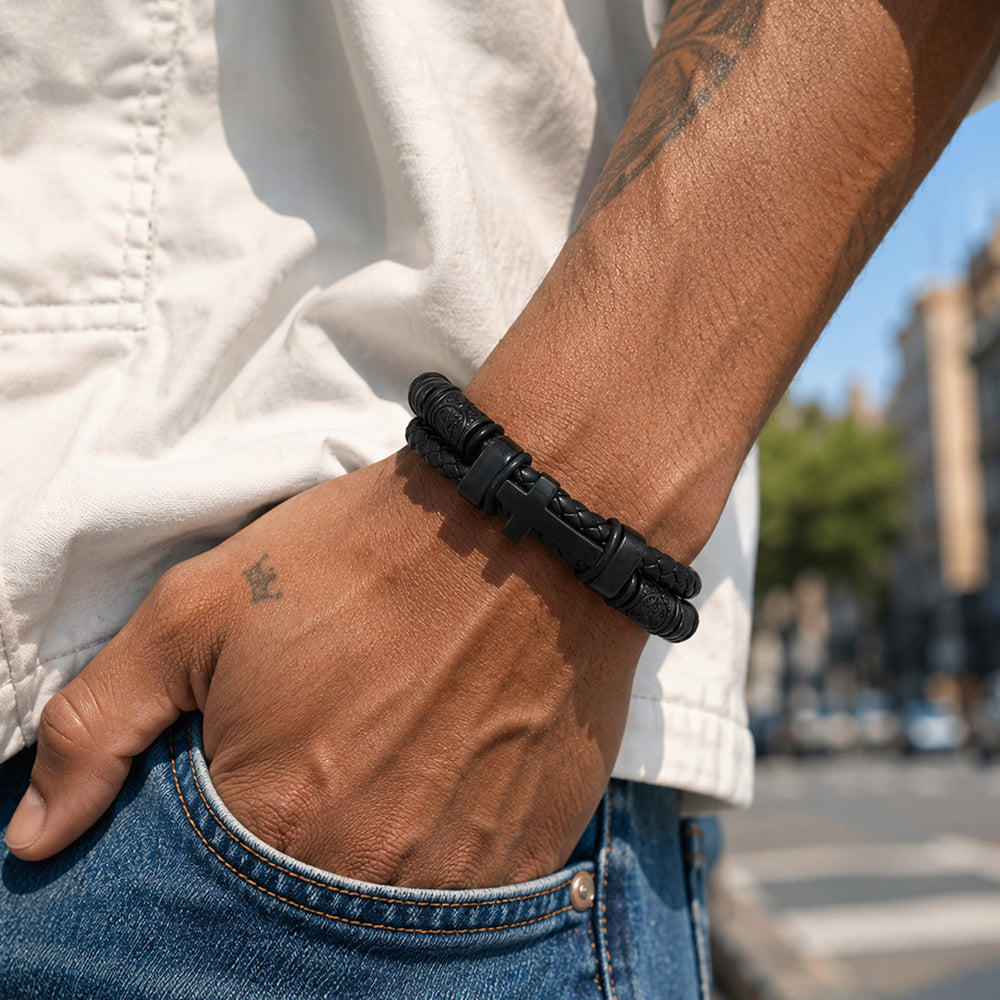 Man wearing Celtic cross braided leather bracelet on wrist, front view