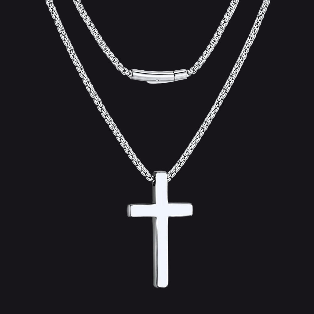 Silver cross necklace on a white background