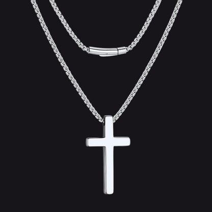 Silver cross necklace on a white background