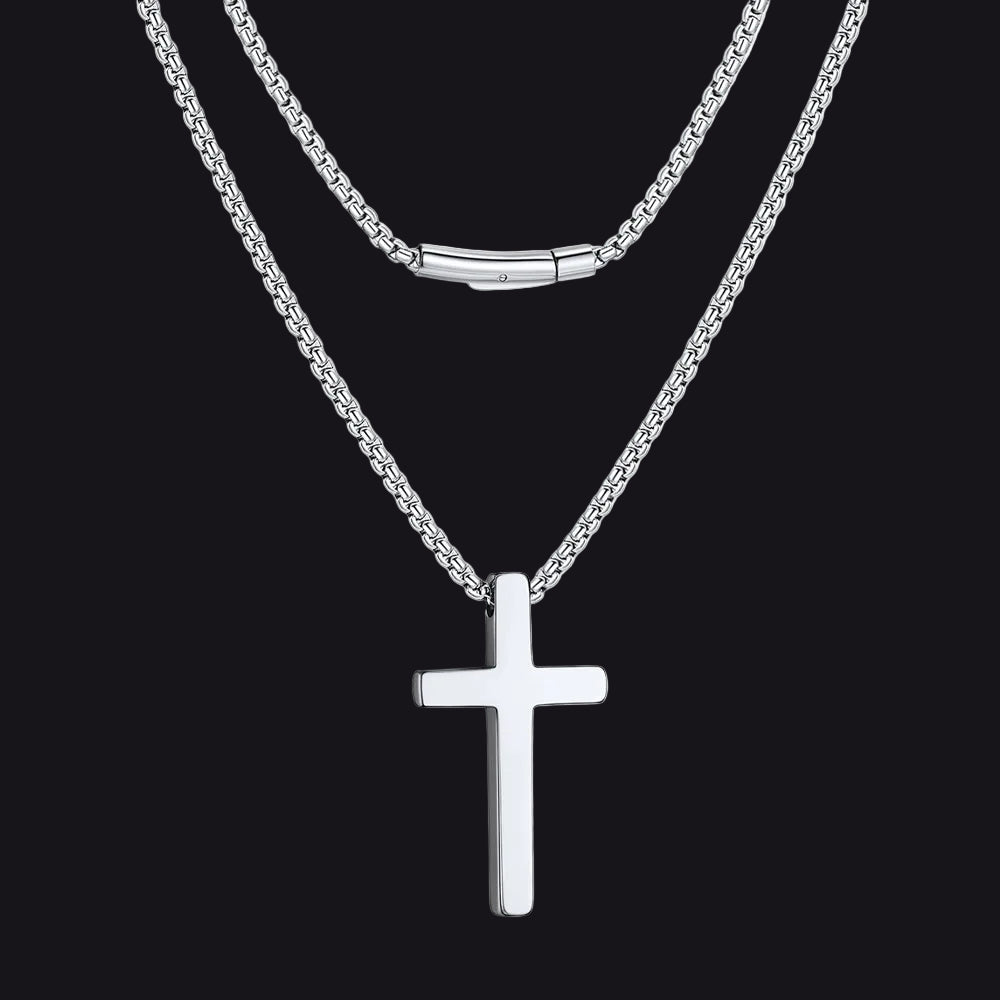 Silver cross necklace on a black  background