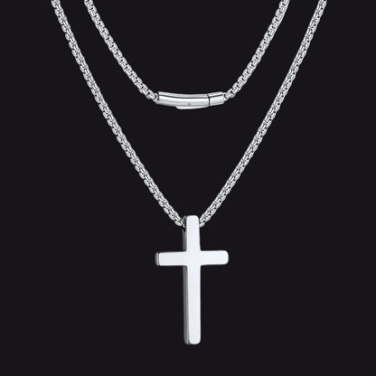Silver cross necklace on a black  background