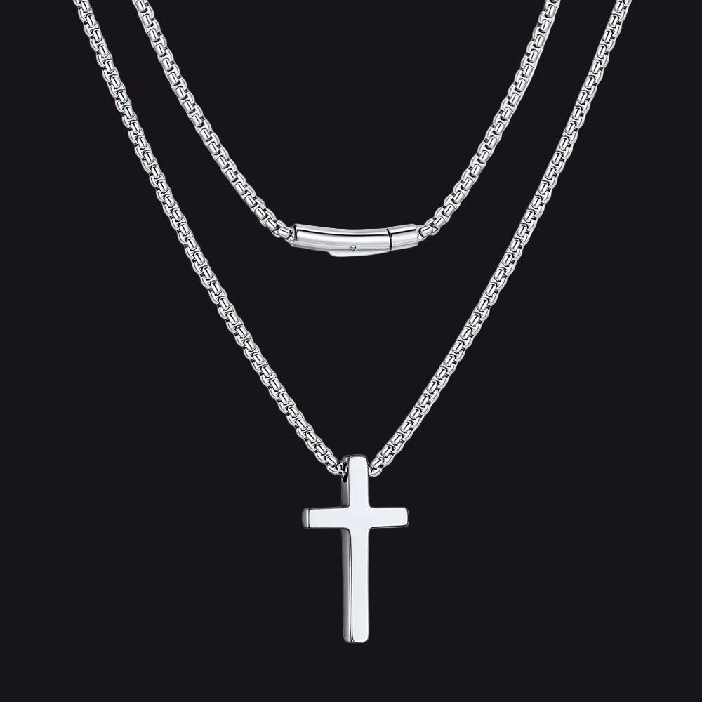 Silver cross necklace on a black background