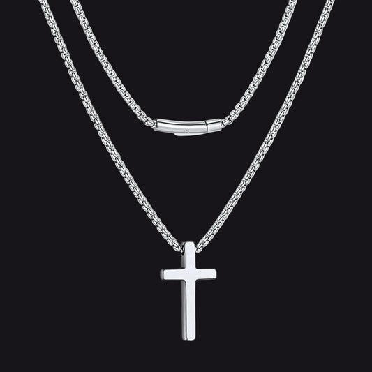 Silver cross necklace on a black backgroundimg