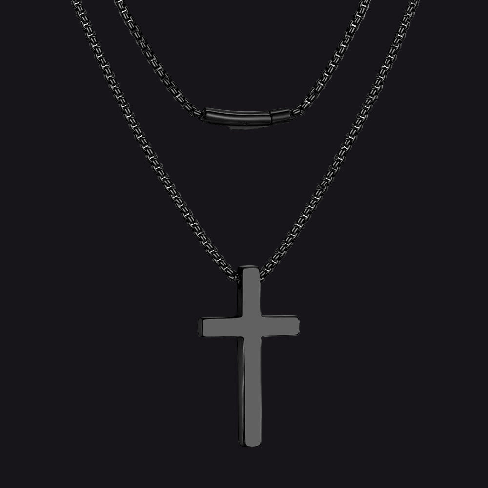 Black cross pendant necklace on a white background