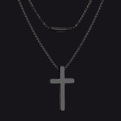 Black cross pendant necklace on a white background