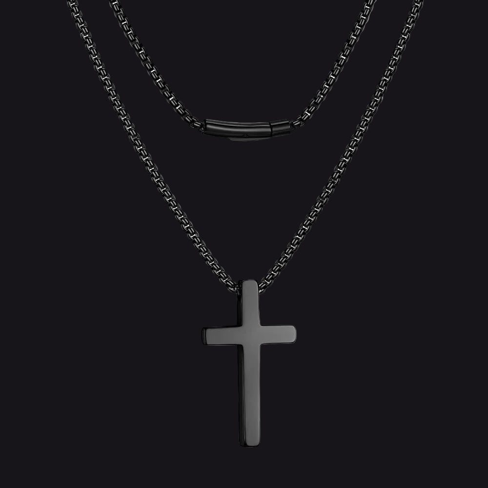 Black cross pendant necklace on a white background