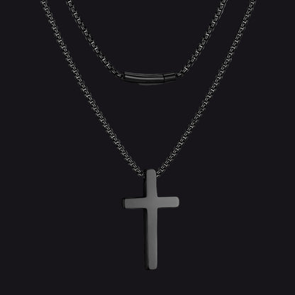 Black cross pendant necklace on a white background