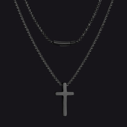 Black cross pendant necklace on a black background