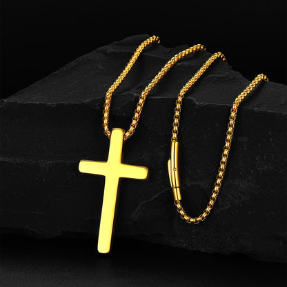 Gold cross pendant and chain on a dark stone surface