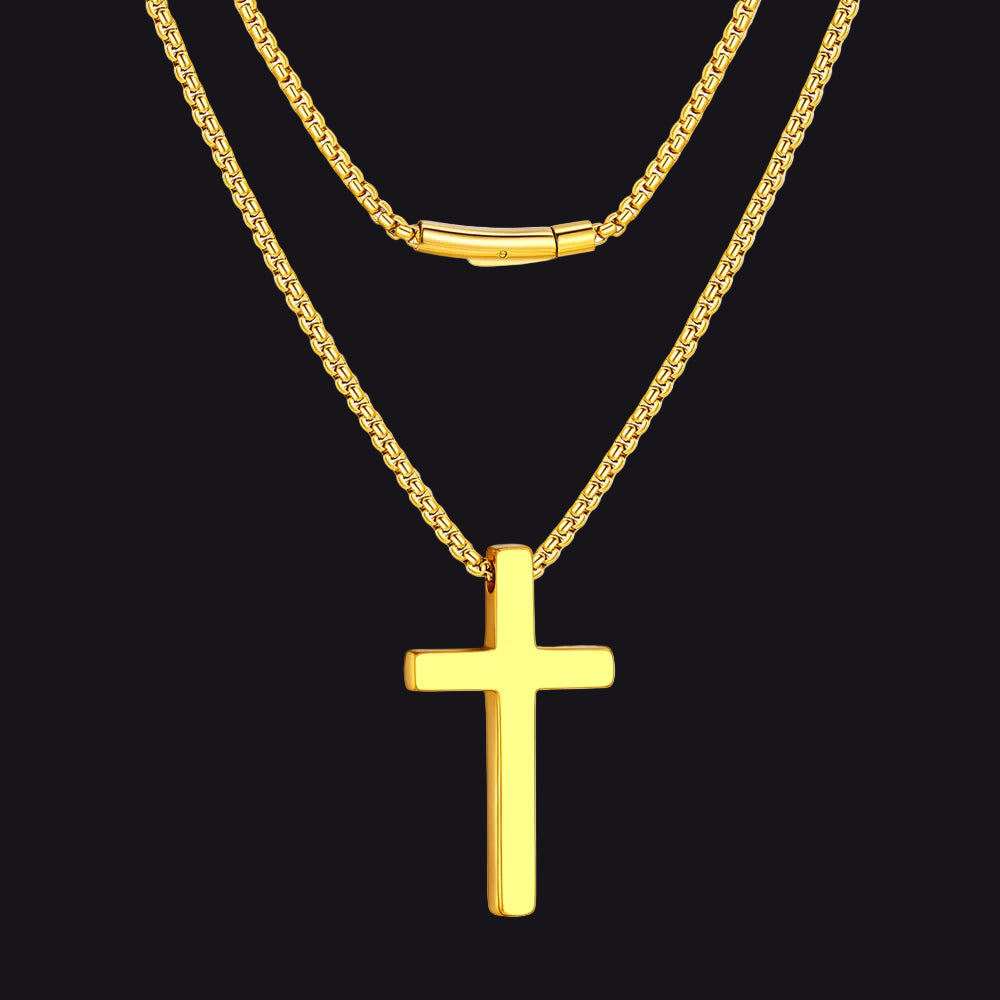 Gold cross necklace on a black background