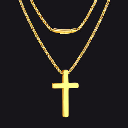 Gold cross necklace on a black background