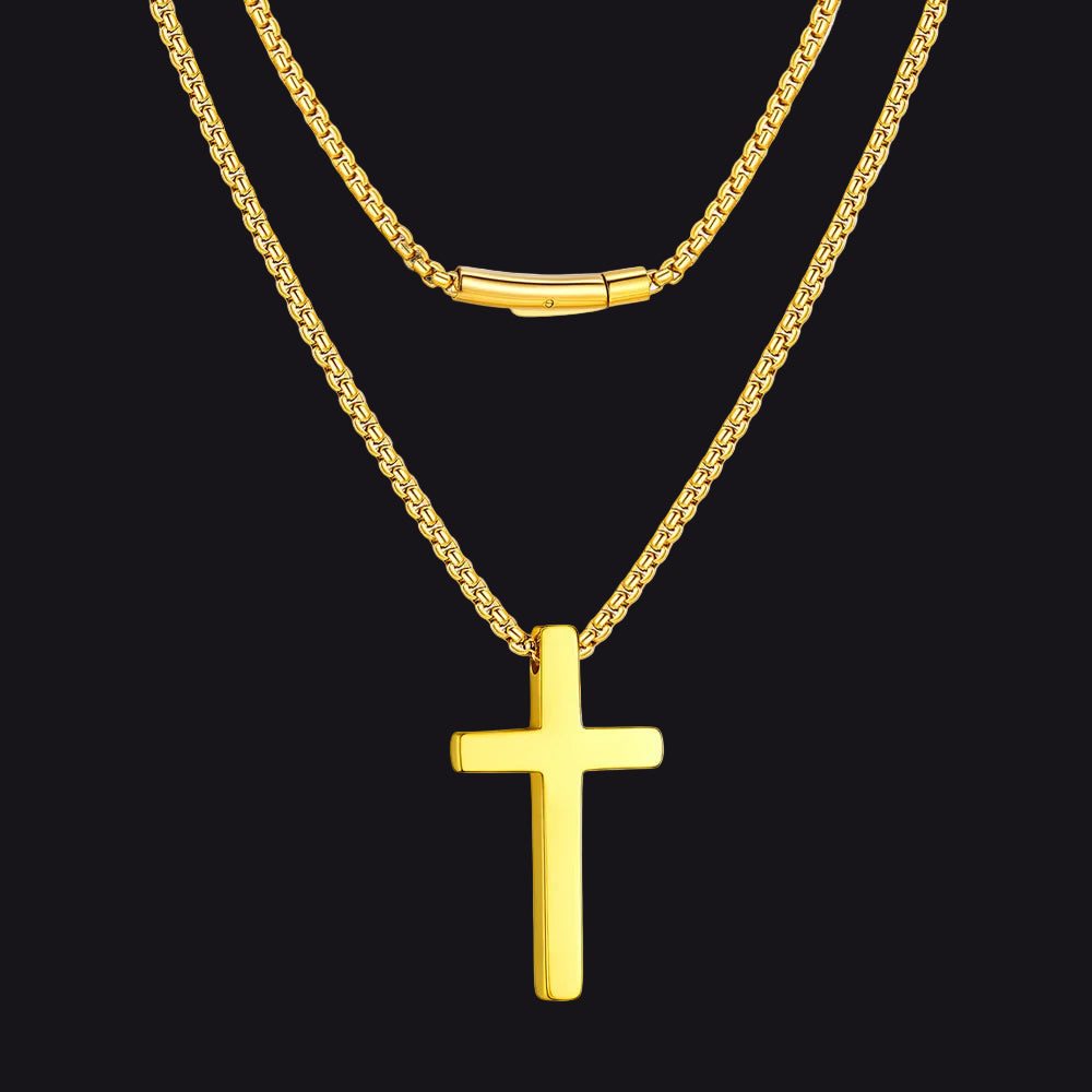 Gold cross necklace on a black background