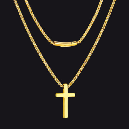 Gold cross necklace on a black background