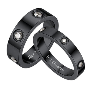 Black wedding bands with diamond accents and 'Her King' and 'His Queen' engraving on a white background