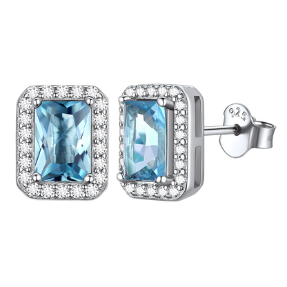 Silver stud earrings with blue cubic zirconia and a halo design