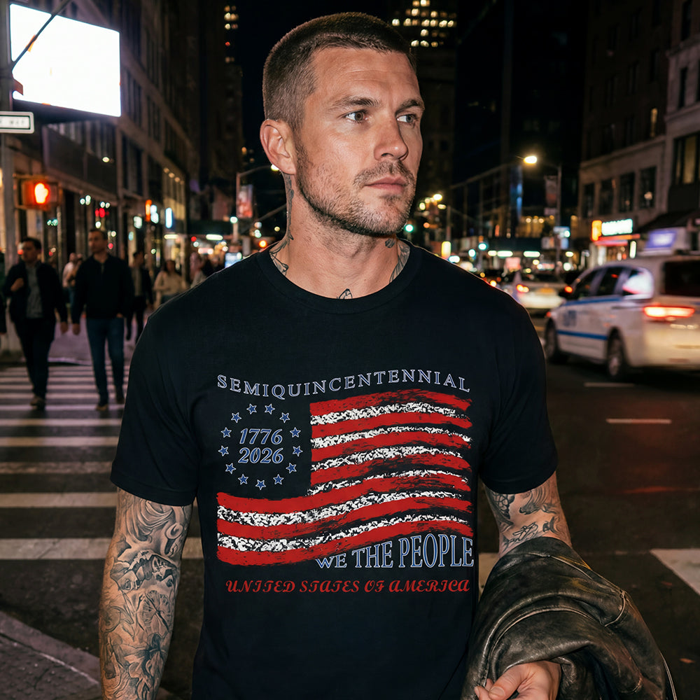Man wearing a black USA Flag Patriotic T-Shirt on a city street at night
