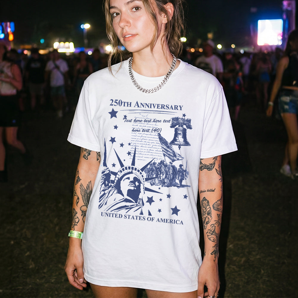 Person wearing a white t-shirt with a graphic design at a concert or event.