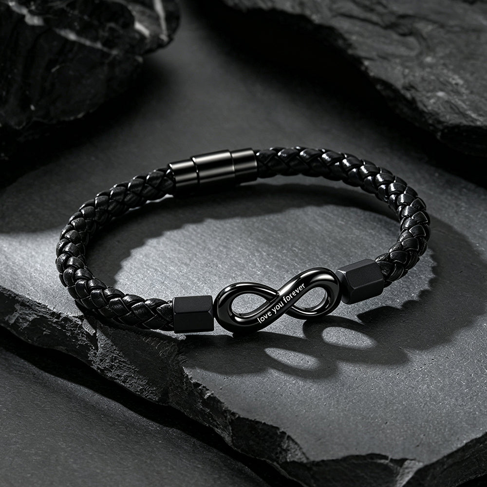 Close-up of infinity knot charm and custom engraving on braided leather bracelet
