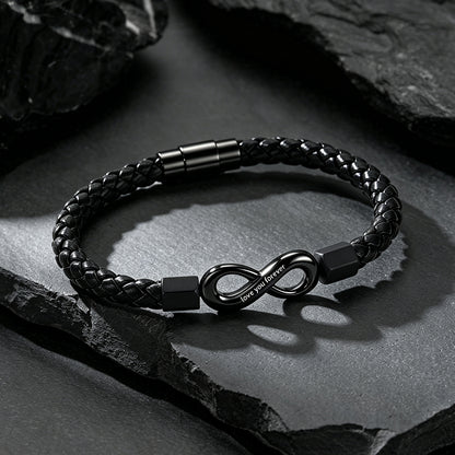 Close-up of infinity knot charm and custom engraving on braided leather bracelet
