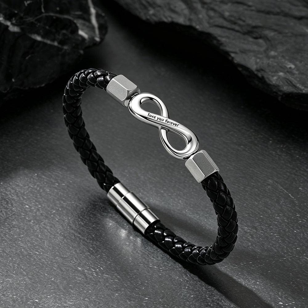 Close-up of infinity knot charm and custom engraving on braided leather bracelet