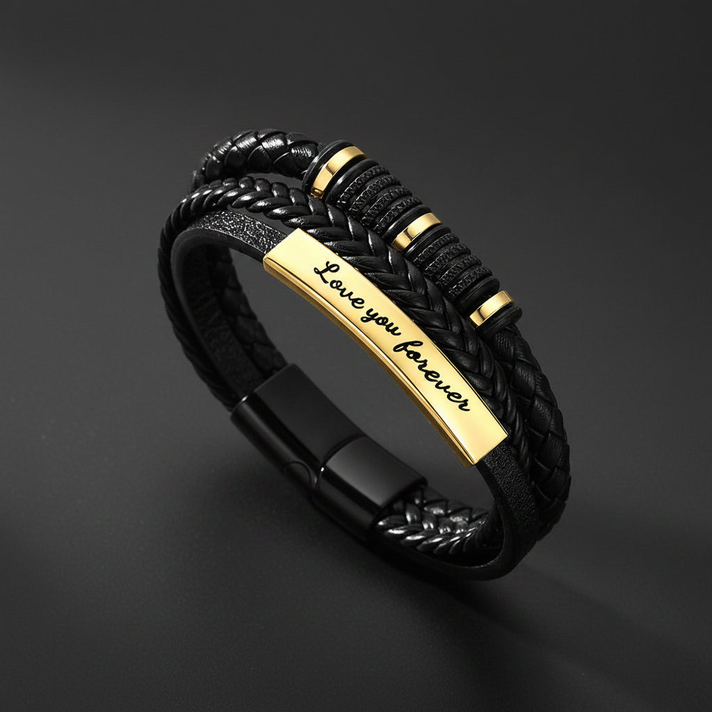 A black braided leather bracelet with a polished gold-plated ID bar engraved with 'Love you forever'.