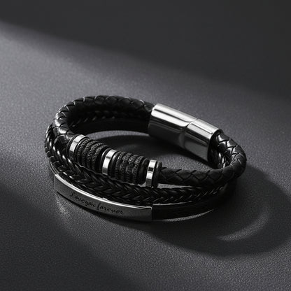 A black braided leather bracelet with a silver-toned metal clasp and a polished bar engraved with 'Love you forever'.