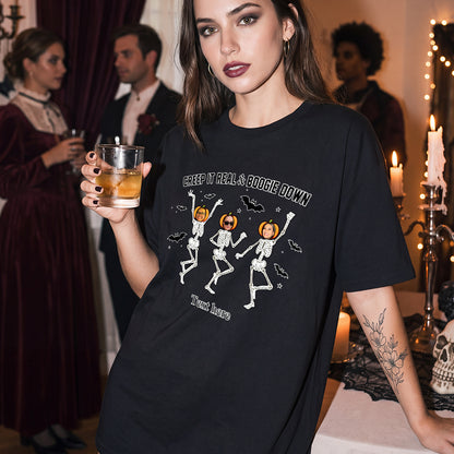 A woman at a Halloween party wearing a black graphic t-shirt with white skeleton illustrations.