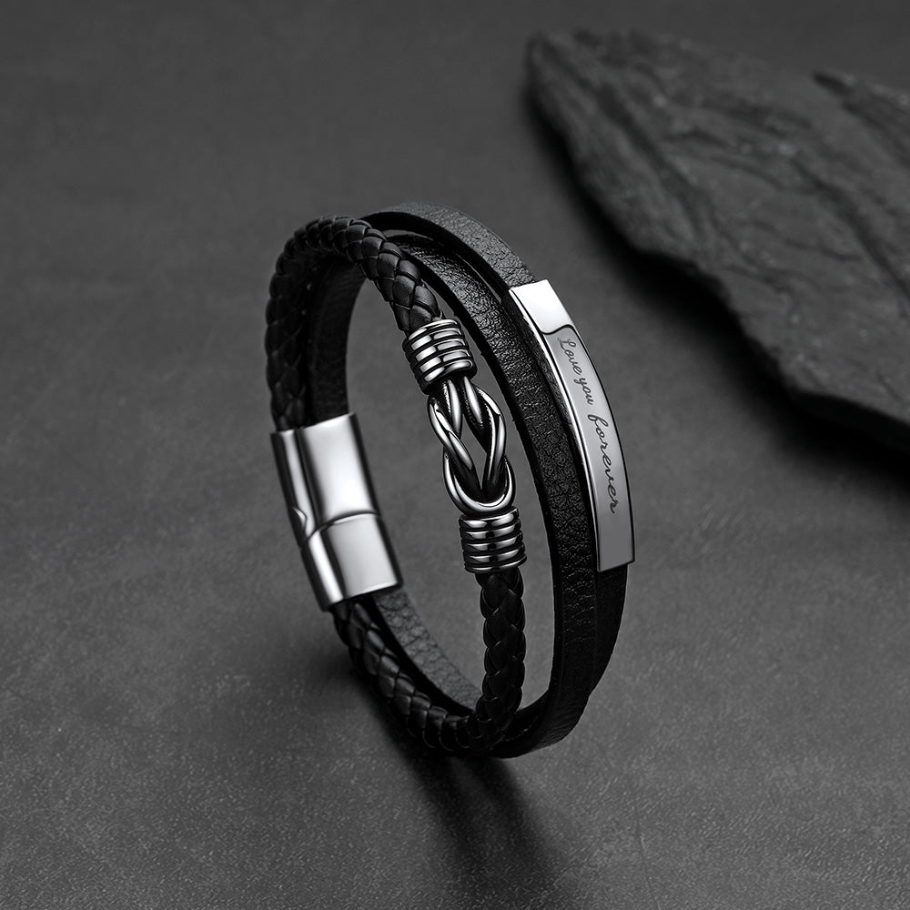 Close-up of infinity knot design and custom engraving on multi-layer leather bracelet