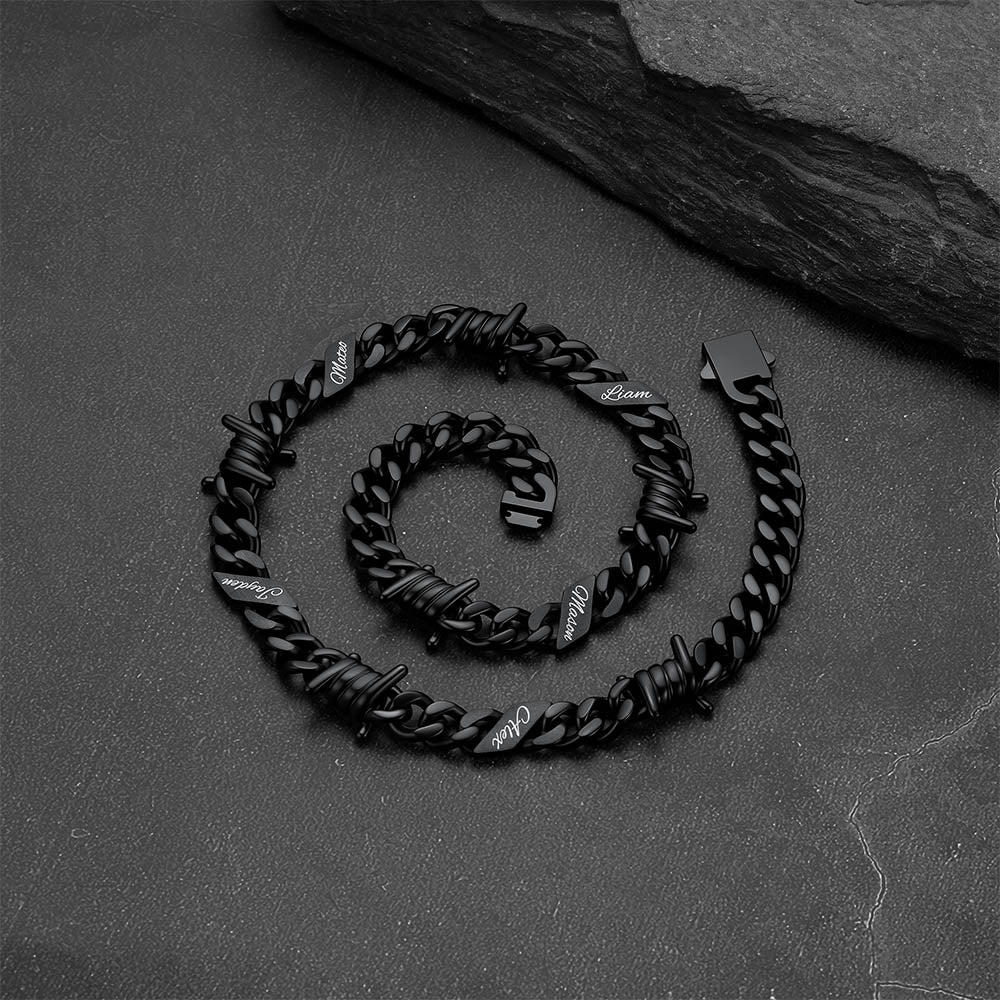Close-up of barbed wire detail and engraved name on Cuban link chain necklace