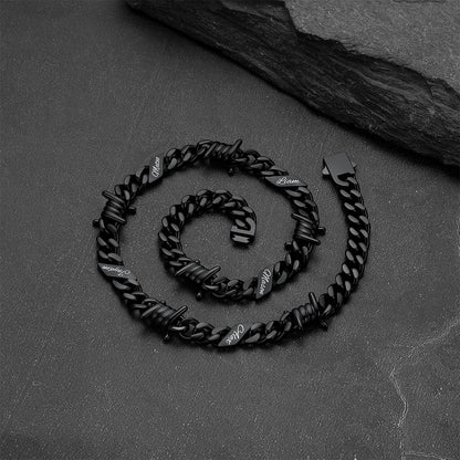 Close-up of barbed wire detail and engraved name on Cuban link chain necklace