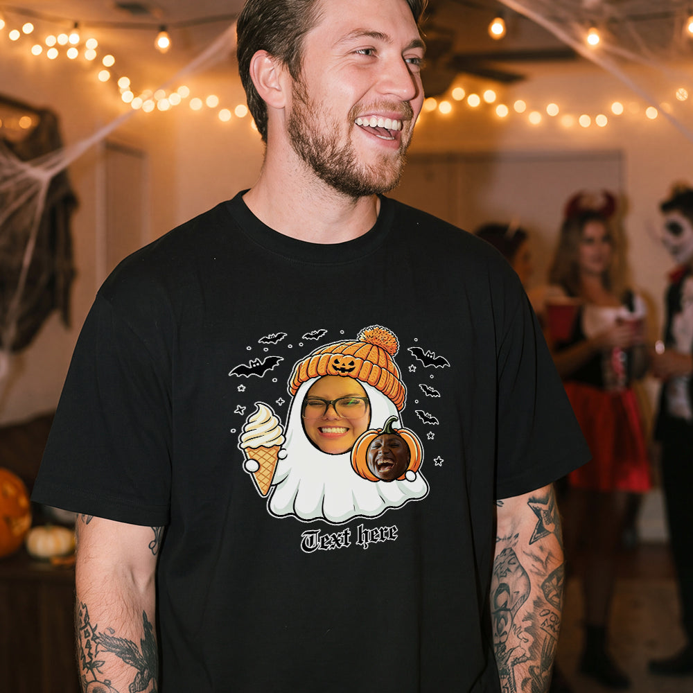 A man wearing a black graphic t-shirt with a Halloween-themed ghost.