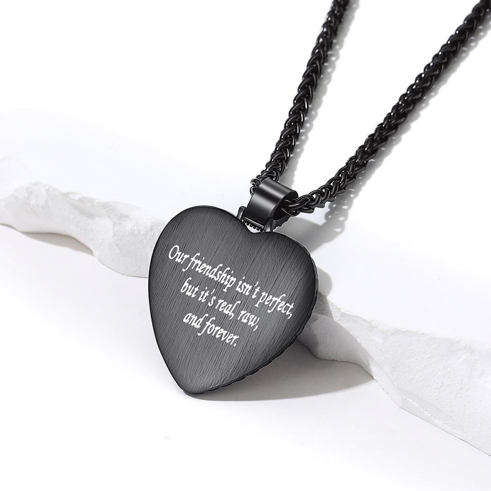A black heart-shaped pendant necklace engraved  text