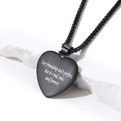 A black heart-shaped pendant necklace engraved  text