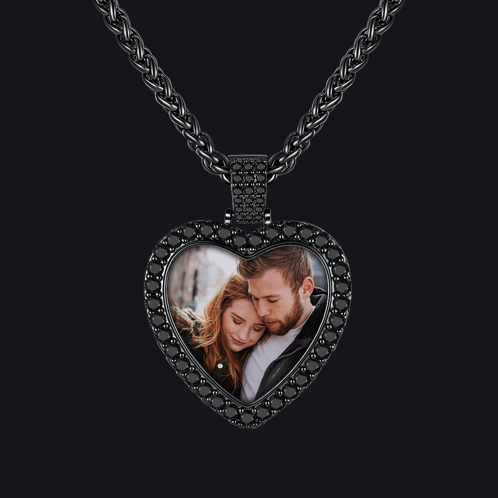 A black heart-shaped photo pendant necklace featuring a custom photo of a couple.