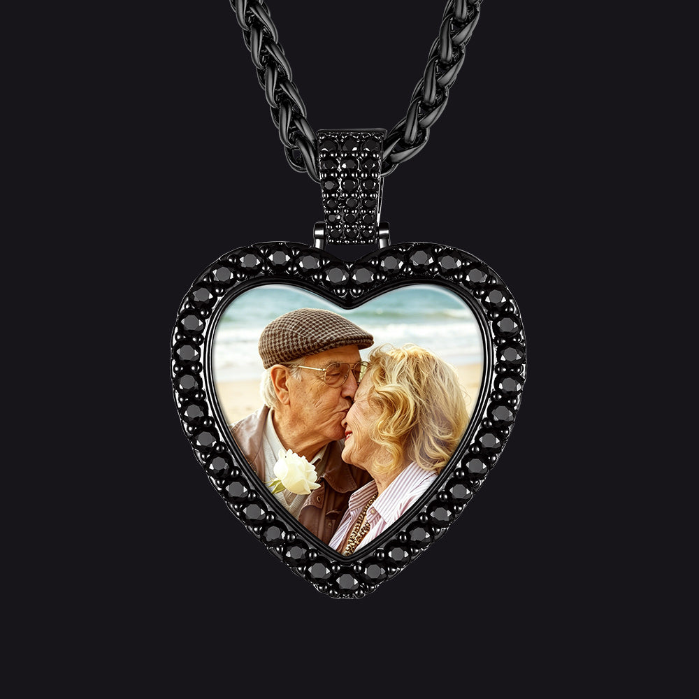 A heart-shaped pendant necklace with a custom photo insert of an elderly couple.
